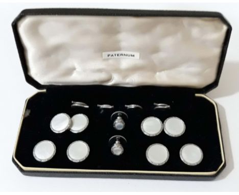 A cased Art Deco style gent's mother of pearl and white metal button and cufflink set. 