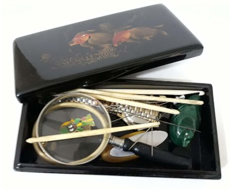 A box of items including an ivory bangle circa 1900, an agat duck, a Robertsons badge, a magnifying glass, bone crochet hooks