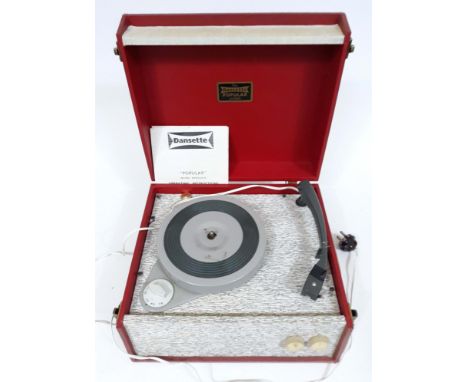 A Dansette "Popular" portable record player in red and textured grey with original instructions. 