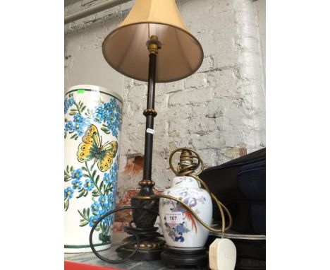 A metal lamp with shade and a porcelain lamp 