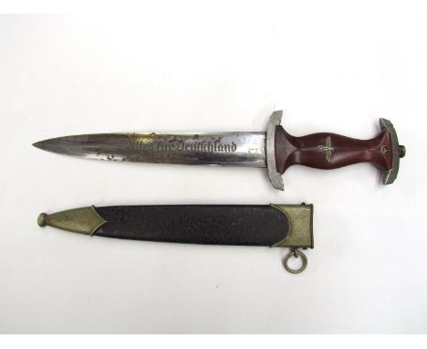 A German design SA type dagger with RZM marking. The hardwood grip set with inset eagle and swastika, with roundel to end, tw