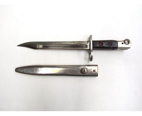 A British No. 5 Mk. I knife bayonet for the Jungle Carbine, with bowie blade dated 1946. Polished steel scabbard