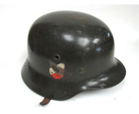 A Third Reich era German M1935 helmet with twin decals, rolled rim and riveted air vents, original liner marked with Chr. Web