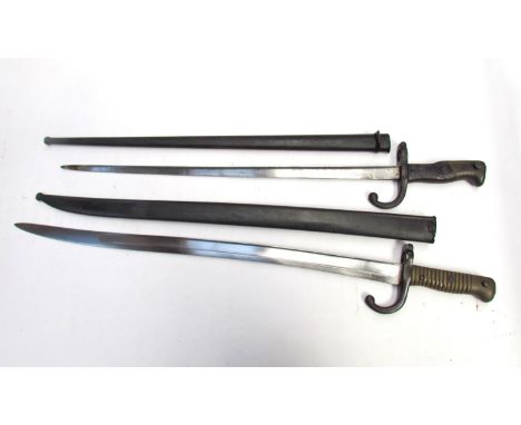 A late 19th Century French Chassepot sword bayonet with brass ribbed grip, hooked quillon and all-steel scabbard, together wi