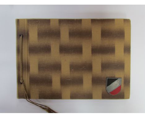 A WWII German Army photograph album with approximately 41 photos, Africa Corps pith helmet decal to the cover