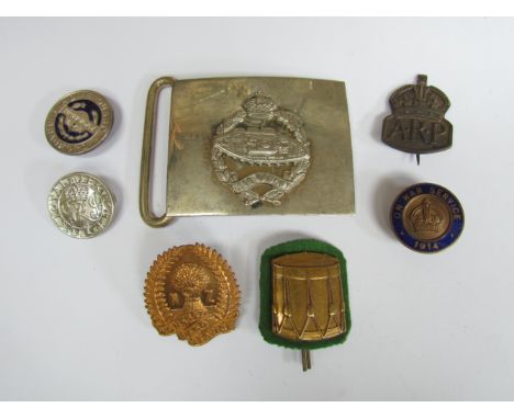 A RTC belt buckle with assorted badges including 1914 On War Service, New Zealand Women's Land Army, ARP and King's Loyal Ser