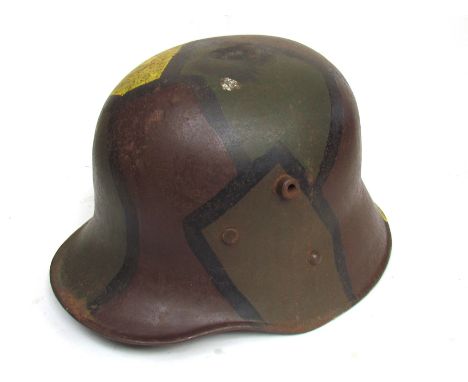 A WWI style German design camouflage helmet with liner