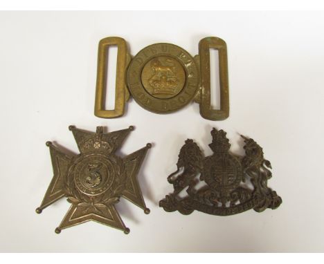 A Victorian brass belt buckle "Dieu Et Mon Droit" together with a British coat of arms badge and a Middlesex 3rd Rifle Volunt