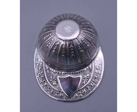 A silver jockey cap form caddy spoon.  5.5 cm long.