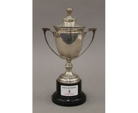 A small silver lidded trophy cup. 18.5 cm high overall. 202.2 grammes.