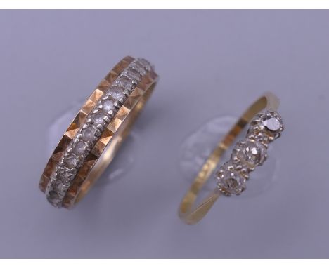 An 18 ct gold and platinum three stone ring (2 grammes total weight) and a gold eternity ring (3.2 grammes total weight). The