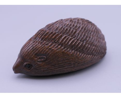 A wooden netsuke formed as a hedgehog.  5 cm long.