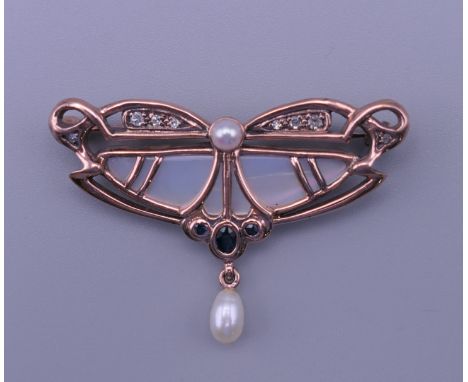 An Art Nouveau style 10 K gold, pearl and diamond brooch.  4.5 cm wide, 3 cm high. 6.6 grammes total weight.