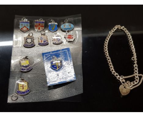 11 UK ENAMEL SHIELD CHARMS ALL MARKED SILVER (ONE MOUNTED ON CARD ASSUMED TO BE SILVER) TOGETHER WITH A SILVER CHARM BRACELET