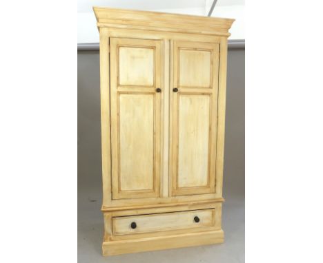 Painted pine wardrobe, the cornice above an arrangement of two panel doors above a drawer, 197x 114cm