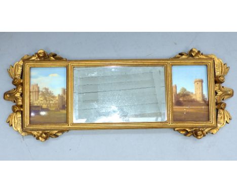 A gilt framed three panel overmantle mirror. The central bevelled glass flanked by pictorial panels of castles, 34x 88cm over