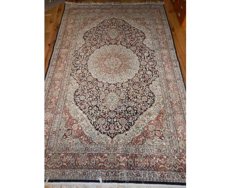 Silk carpet, Qom style with floral design over cream and black ground, 254x 151cm w