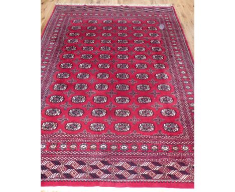 Large Turkoman style carpet, traditional elephant pad medallions to centre within reticulated borders, 360x280cm