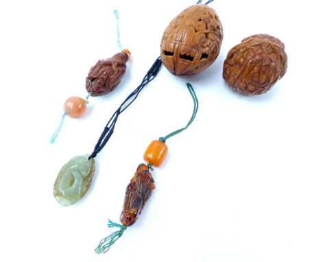 Carved hardwood netsuke, modelled in the form of a scholar mounted on a green cord, together with a similar carved amber nets