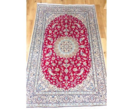 Part silk and wool Nain carpet, overall with traditional floral design over red quatrefoil medallion to centre, fringed, 