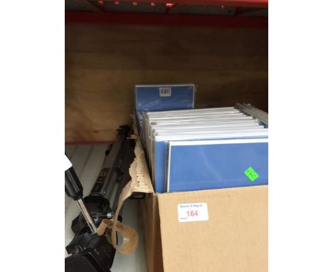 A CAMERA TRIPOD AND A BOX OF CARDS