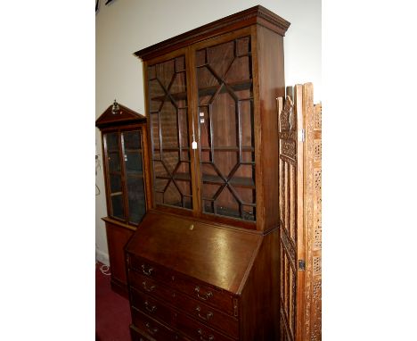 A George III mahogany bureau bookcase, the upper section having twin astragal glazed doors enclosing adjustable shelves, the 
