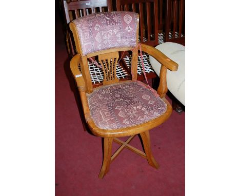 A 1930s light oak and floral upholstered splatback tub swivel desk chair 