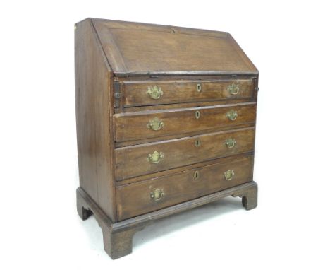 A George III oak bureau, fall front with fitted interior, four graduating drawers with brass handles, raised on bracket feet,