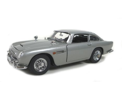 A Danbury Mint 1:24 scale detailed diecast model, 'The James Bond 007 Aston Martin DB5', serial B4852, with original cardboar