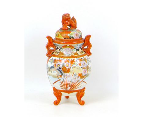 A Japanese Kutani vase and cover, with sealed cover topped with a lion, lug handles, and two reserves decorated with floral s