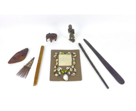 A collection of eight tribal items, including part of an Eastern profusely carved staff, decorated with flower and birds, wit
