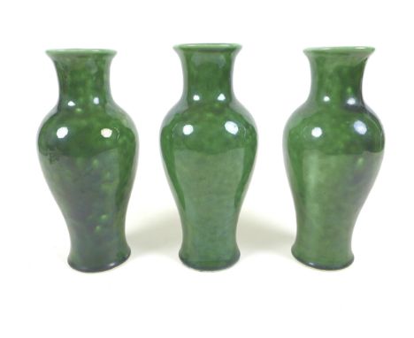 A set of three matching mottled green glazed table lamp bases, mid 20th century, of baluster form with holes to the top surfa