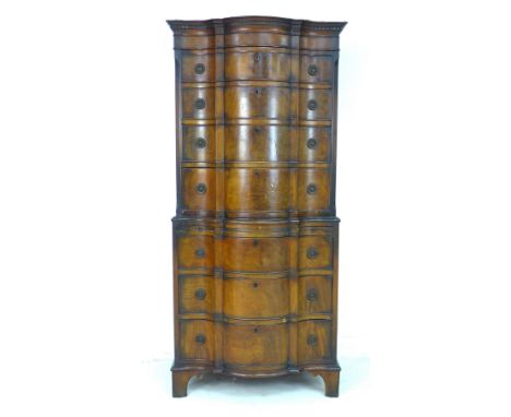 A 20th century serpentine front mahogany tall boy, chest of chest, in two sections, with dentil cornice over seven graduating