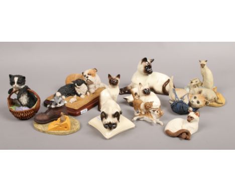 A collection of composite and ceramic cat figures to include Beswick, Sherratt and Simpson etc.