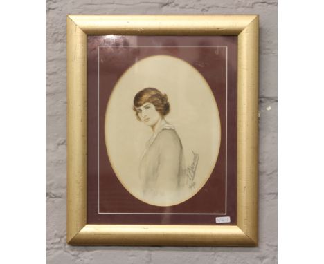 A gilt framed early 20th century mixed media portrait of a woman, signed and dated.
