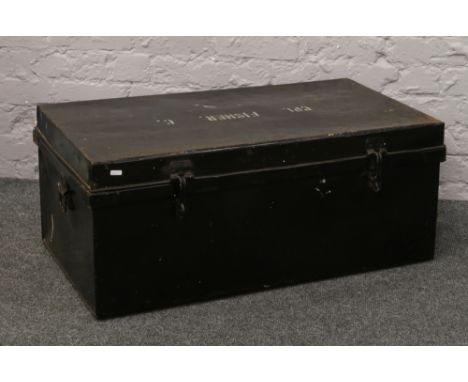 A black metal twin handle military trunk stencilled CPL Fisher.
