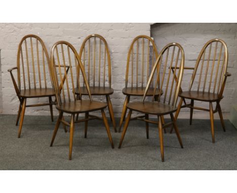 A set of six Ercol spindle back dining chairs to include two carvers.