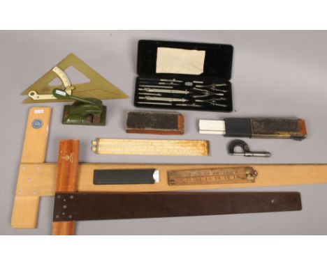 A collection of drawing equipment to include Riefler cased compass set, folding rulers, set squares, Rufford E21BOSS letter s