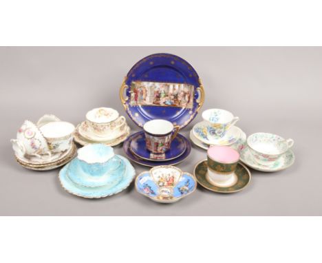 A collection of porcelain cups and saucers, trios etc to include Royal Worcester and hand painted examples.