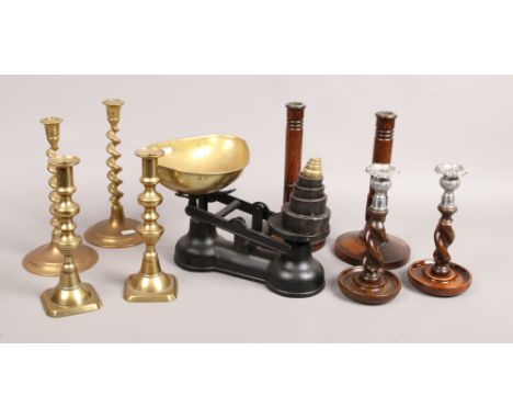 A set of iron and brass kitchen scales and weights, two pairs of oak candlesticks and two pairs of brass candlesticks.