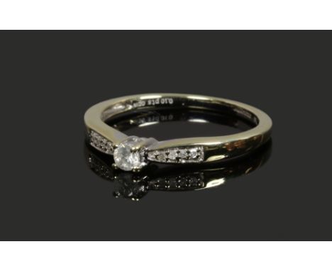 An 18ct white gold diamond solitaire ring with diamond shoulders, size K.