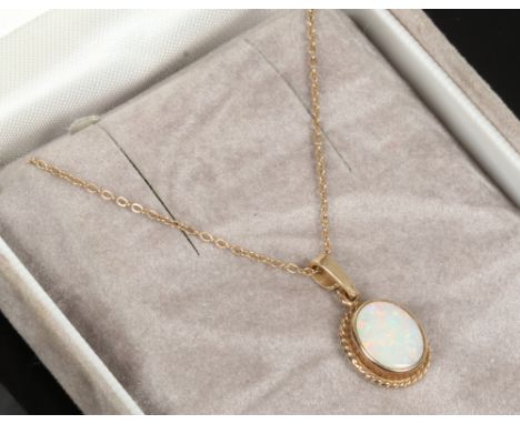 A 9ct gold mounted oval opal pendant on 9ct gold chain.