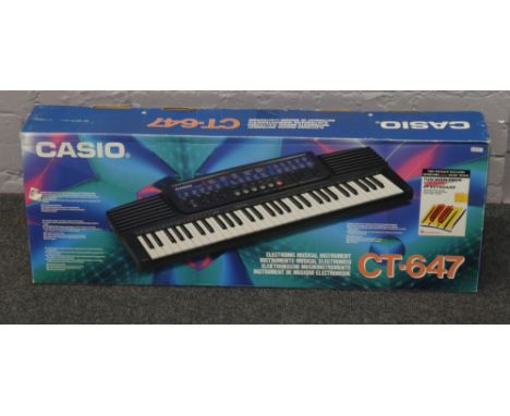 A boxed Casio CT-647 keyboard.
