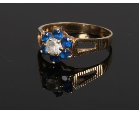 A 9ct gold diamond and sapphire ring of floriform, size K.