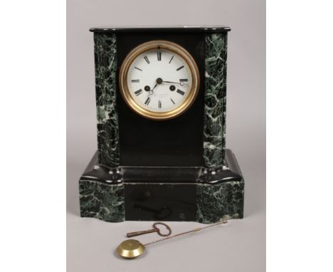 A French slate and marble 8 day mantel clock by F. Poulet Paris chiming on a bell.