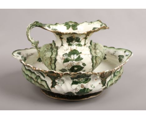 A large jewel ceramic jug and bowl, decorated with leaves and flowers.