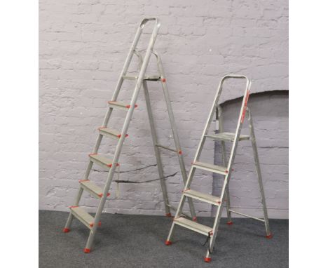 Two sets of aluminium step ladders.