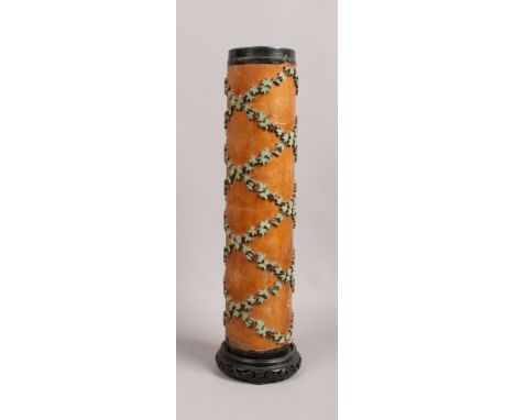 A wallpaper printing roll formed as a table lamp base decorated with trailing foliage, height 58cm.