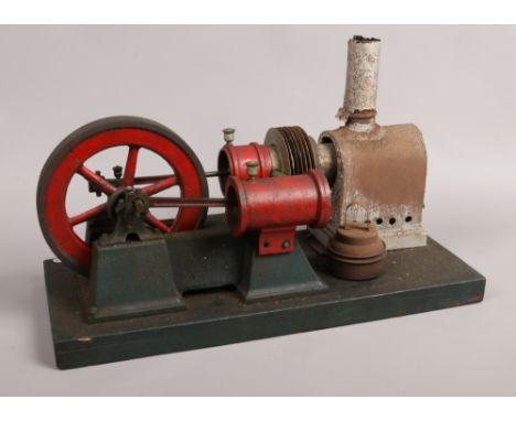 A stationary live steam model engine with twin pistons.