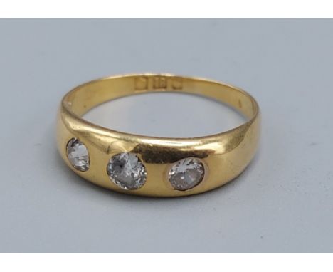 An 18ct gold three stone Diamond ring, 2.9gms, ring size L 